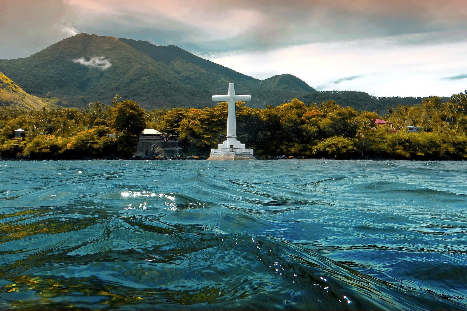 The giant white cross of the Sunken Cemetery standing in the sea off Catarman, Camiguin